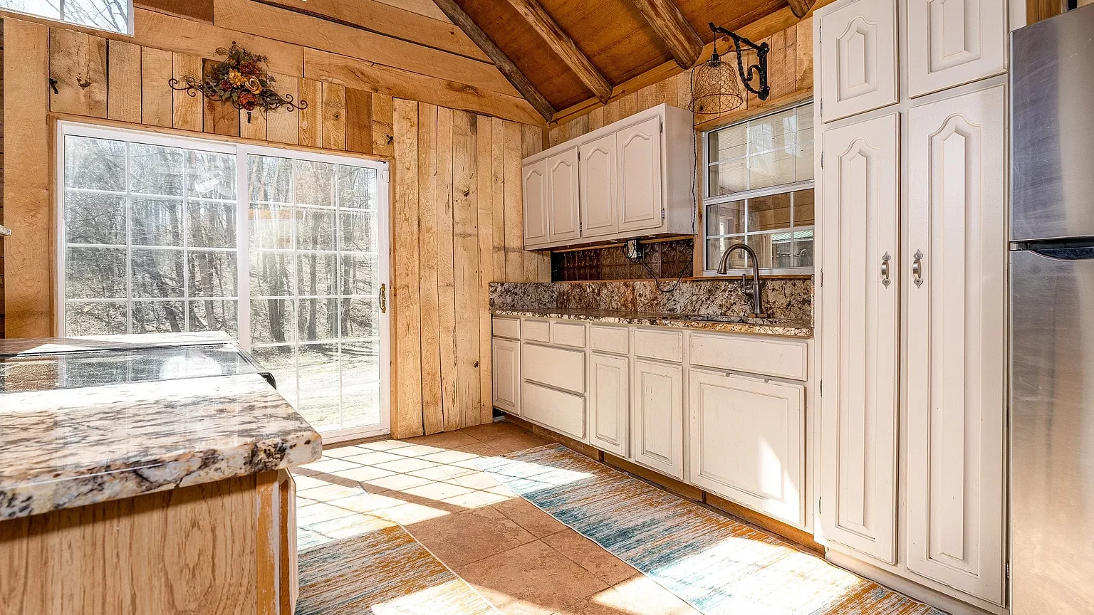 Secluded log cabin for sale in Lyles, TN on 6.5 acres with pond, garage, loft, and workshop. Explore this peaceful Tennessee retreat near Nashville today!