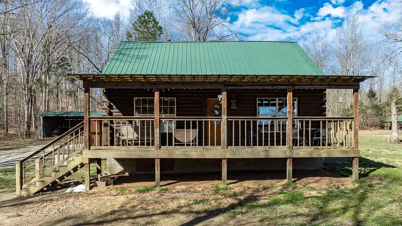 Secluded log cabin for sale in Lyles, TN on 6.5 acres with pond, garage, loft, and workshop. Explore this peaceful Tennessee retreat near Nashville today!