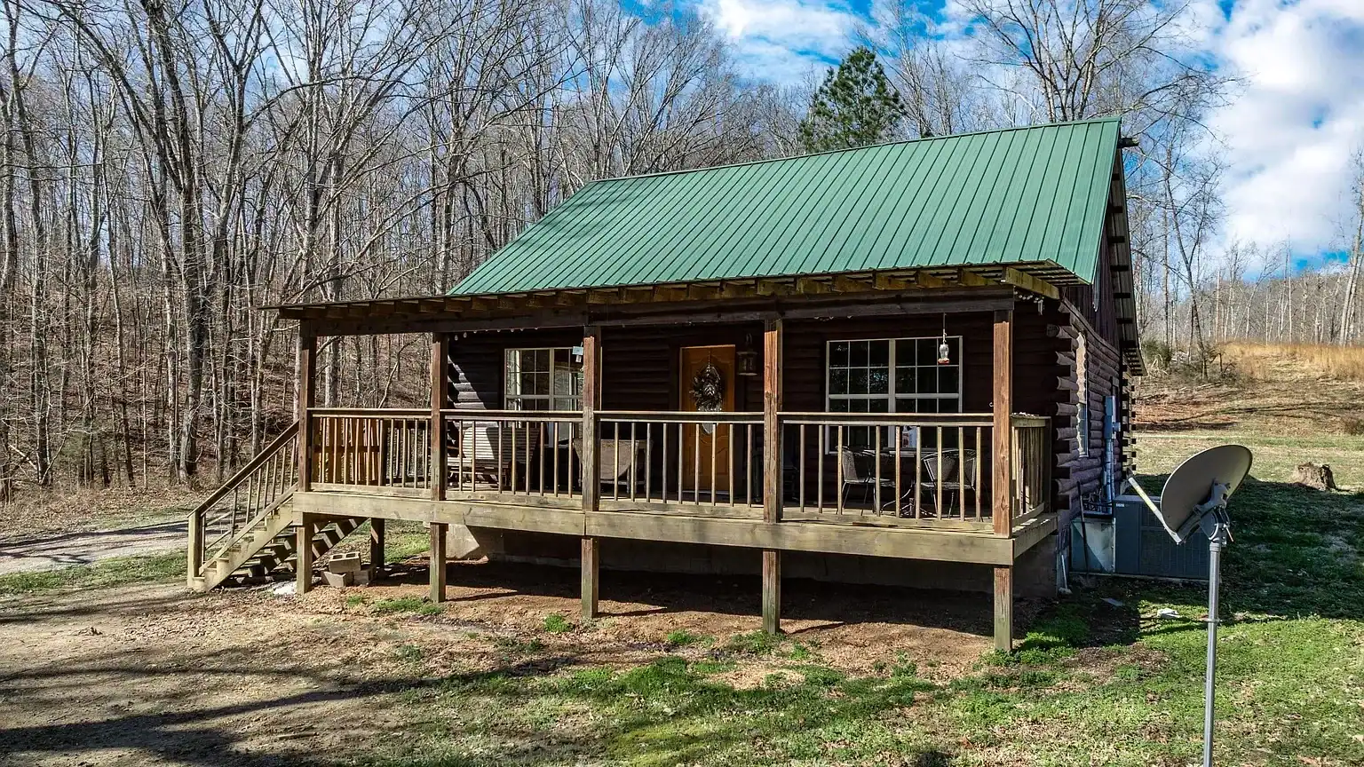 Secluded log cabin for sale in Lyles, TN on 6.5 acres with pond, garage, loft, and workshop. Explore this peaceful Tennessee retreat near Nashville today!