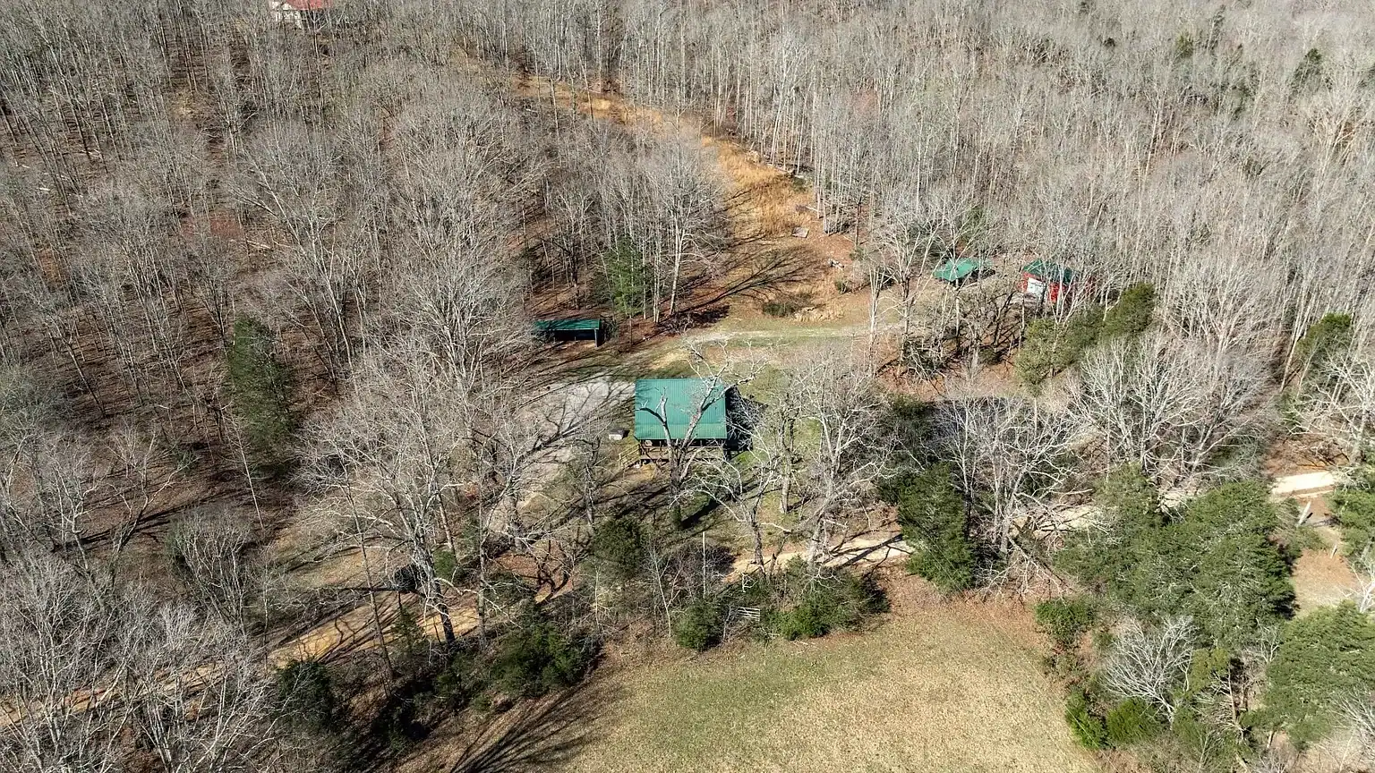 Secluded log cabin for sale in Lyles, TN on 6.5 acres with pond, garage, loft, and workshop. Explore this peaceful Tennessee retreat near Nashville today!