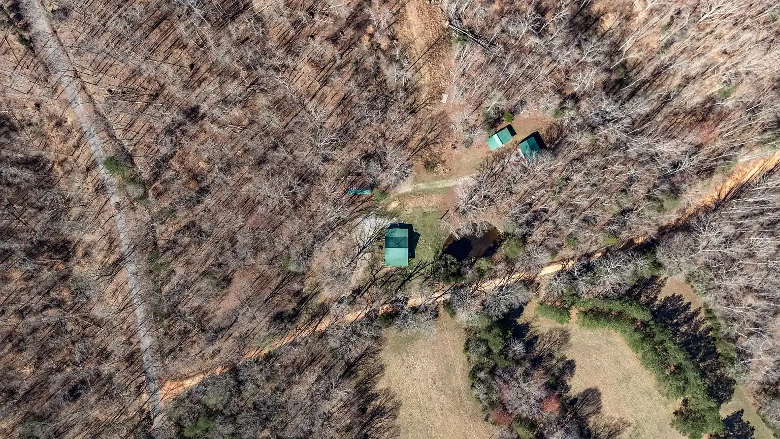 Secluded log cabin for sale in Lyles, TN on 6.5 acres with pond, garage, loft, and workshop. Explore this peaceful Tennessee retreat near Nashville today!