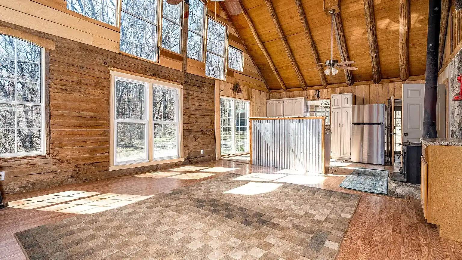 Secluded log cabin for sale in Lyles, TN on 6.5 acres with pond, garage, loft, and workshop. Explore this peaceful Tennessee retreat near Nashville today!