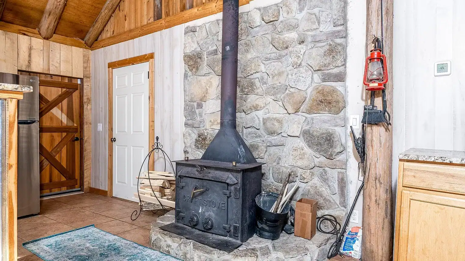 Secluded log cabin for sale in Lyles, TN on 6.5 acres with pond, garage, loft, and workshop. Explore this peaceful Tennessee retreat near Nashville today!