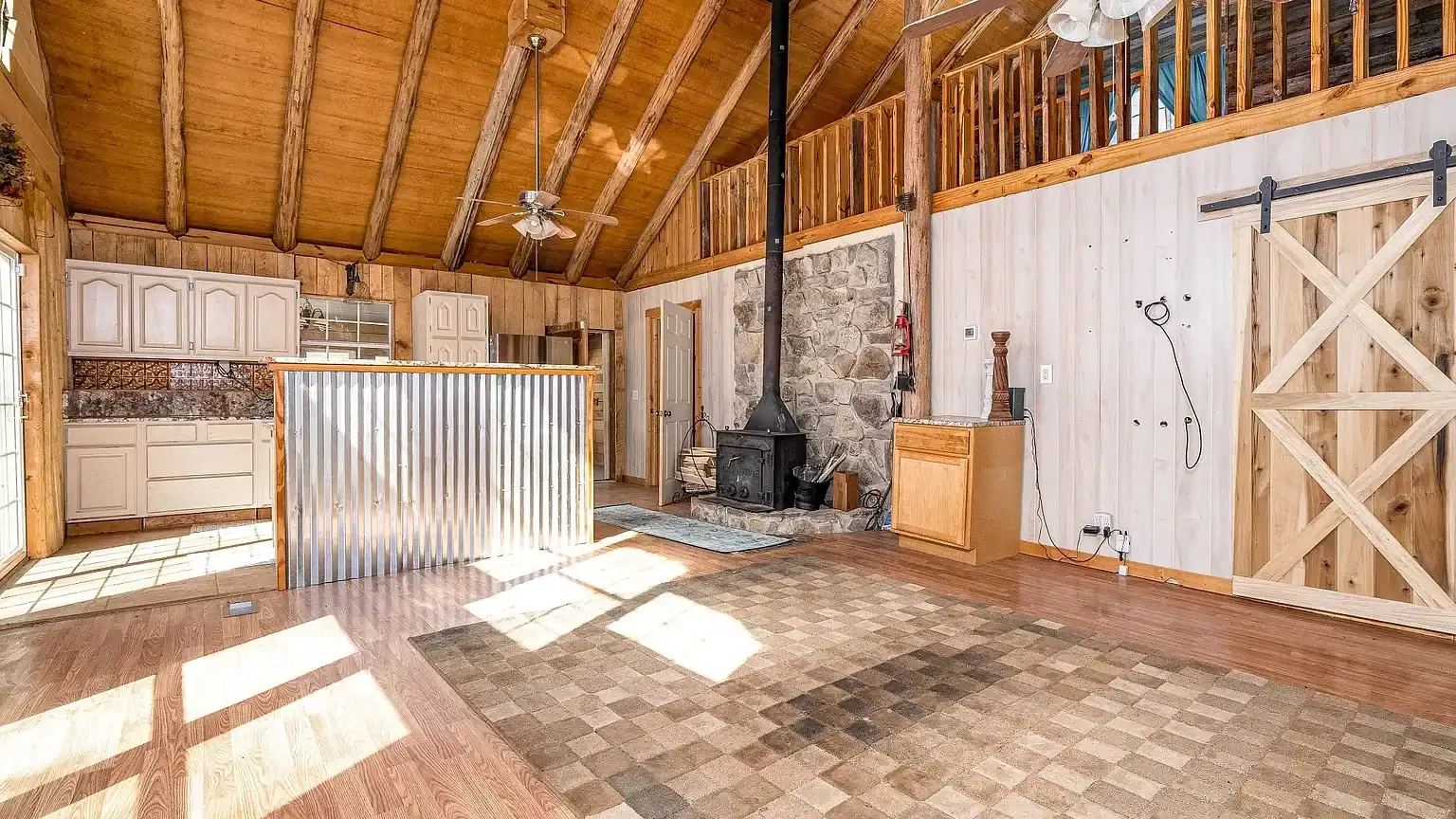 Secluded log cabin for sale in Lyles, TN on 6.5 acres with pond, garage, loft, and workshop. Explore this peaceful Tennessee retreat near Nashville today!