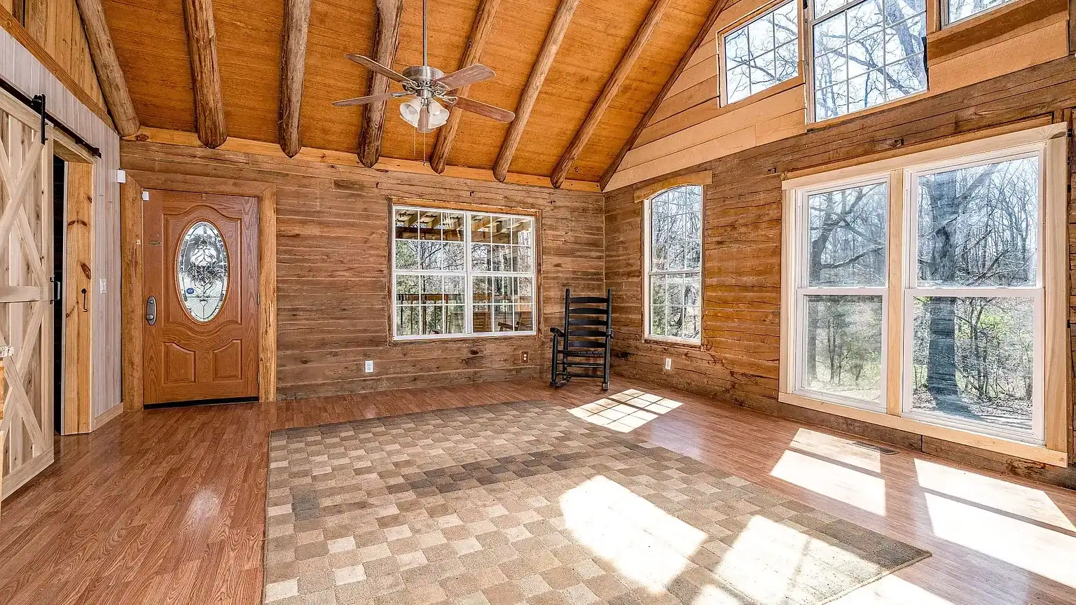 Secluded log cabin for sale in Lyles, TN on 6.5 acres with pond, garage, loft, and workshop. Explore this peaceful Tennessee retreat near Nashville today!